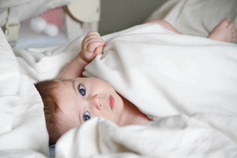 newborn-baby-laying-in-the-bed